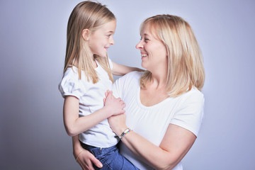 A mother with is daughter over gray background