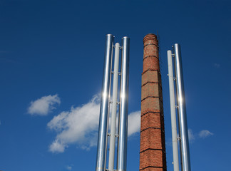 replacement of coal heating to gas. old brick chimney coal-fired boiler and two new metallic pipe gas boiler house on background blue sky.  the concept of progress in the energy industry