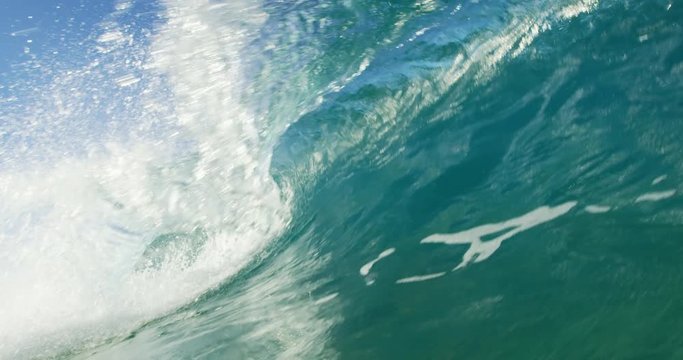 Beautiful blue ocean wave breaking in slow motion