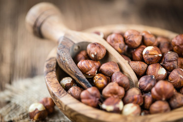 Hazelnuts on vintage wooden background (selective focus)