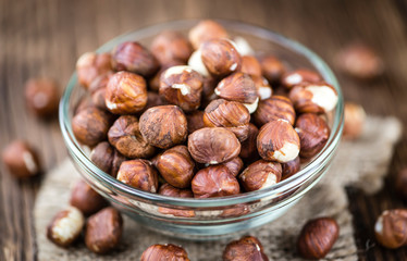Hazelnuts on vintage wooden background (selective focus)