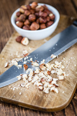 Wooden table with chopped Hazelnuts