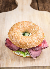 Bagel (with Roast Beef) on vintage background
