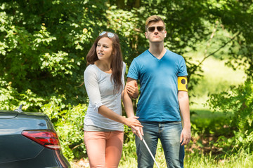 Young Woman Helping Blind Man