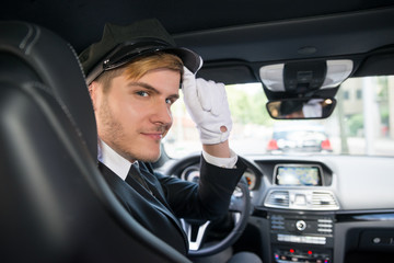 Portrait Of Smiling Young Chauffeur In Car