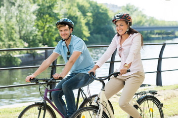 Fototapeta premium Couple On Bicycles Ride In The Park