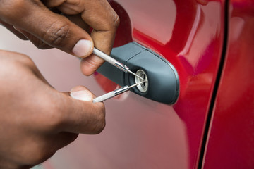 Person Hand Opening Car Door With Lockpicker