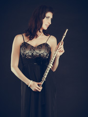 Elegant woman with flute instrument.