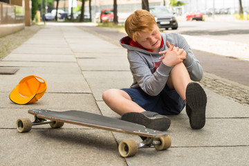 Boy Looking At His Injured Leg