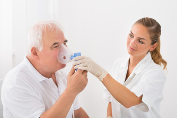 Patient Inhaling Through Oxygen Mask