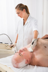 Obraz na płótnie Canvas Man Getting Ultrasound Scan On Neck By Doctor
