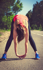 Young fitness woman runner stretching before run. Runner athlete