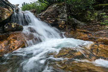 Fototapeta na wymiar small waterfall on the Kamenka river in Khamar-Daban ridge