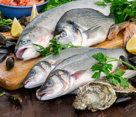 Raw seafood on a wooden board.