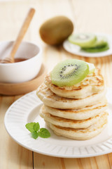 pancakes with honey syrup and fresh kiwi sliced