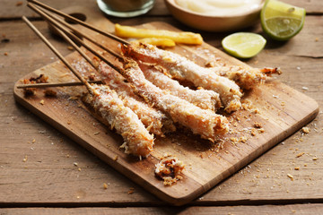 crumbed prawn skewers with potato fries