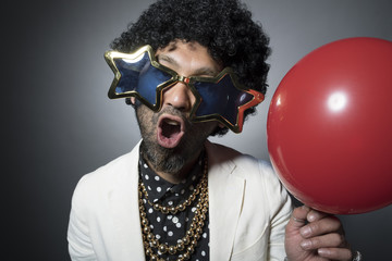 Flashy men who have a red balloon