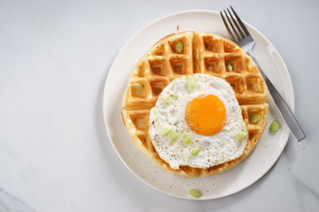 warm waffle with fried egg for breakfast.