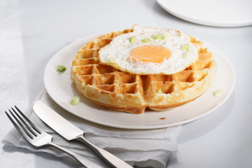 warm waffle with fried egg for breakfast.