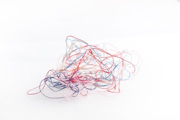 tangled colored thread on a white background,selective focus