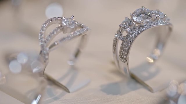 Closeup of two diamond silver ring with beautiful design on jewelry tray