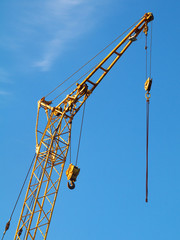 fragment of mobile crane boom against blue sky