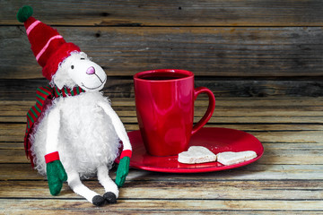 Obraz na płótnie Canvas Christmas, red Cup with coffee and dessert on wooden background