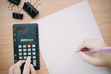 top view of office works with a vintage style, film camera, budget plan