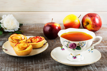 Cup of tea and apple rose shaped muffins
