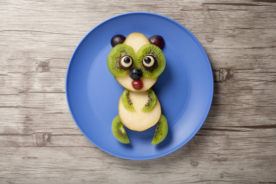 Panda made of fruits on plate and board