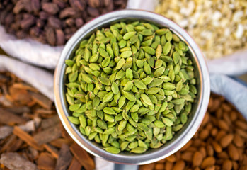 Various of Indian spices on the market in India. Cardamon seeds close-up.