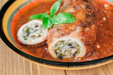 Stuffed squid with parmesan cheese, onion and parsley in tomato sauce.