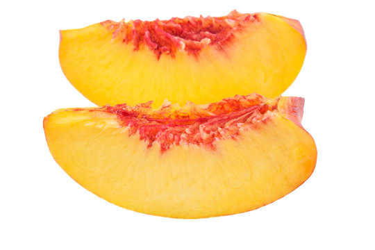 Fresh peach slices on white background - close up image.