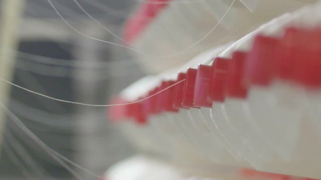Spool of white thread on the textile manufacture