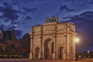 Fototapeta na wymiar Triumphal Arch (Arc de Triomphe du Carrousel) at Tuileries gardens in Paris, France. Monument was built between 1806 - 1808 to commemorate Napoleon's military victories.