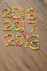 2016 2017 2018 written with colorful candies on wooden backgroun