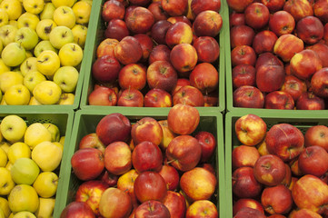 the apples in the boxes on the shelf