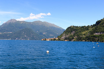 Obraz premium View towards lakeside village Varenna at Lake Como with mountains in Lombardy, Italy