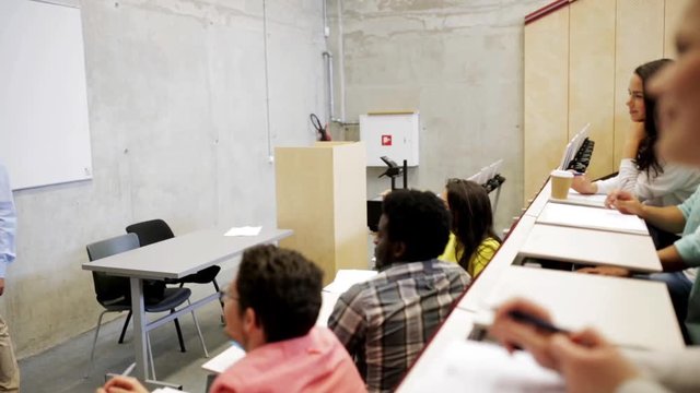 students and teacher at white board on lecture