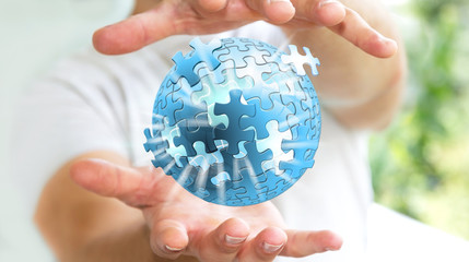 Businessman holding flying puzzle sphere ‘3D rendering’