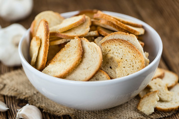 Bread chips on wooden background