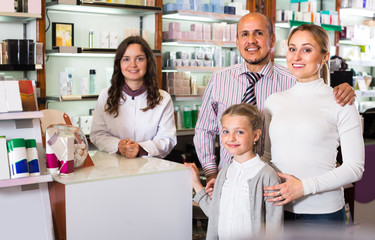 Family with a kid in pharmacy .