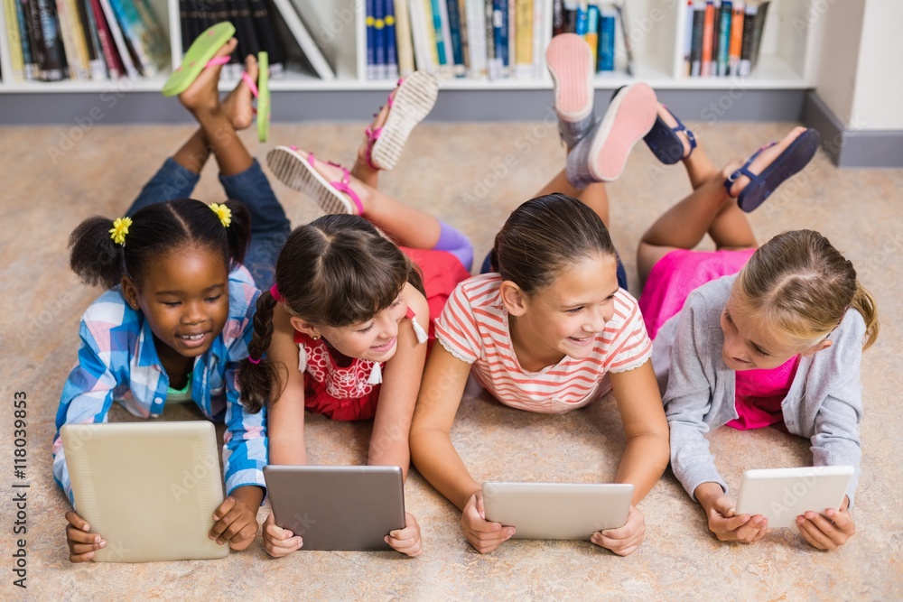 Poster kids using digital tablet in library