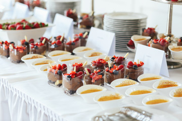 Delicious desserts stand between the bowls of sauce