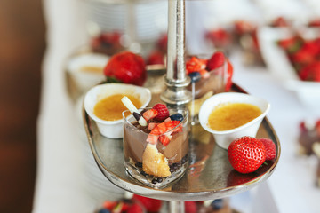 Look from above at the bowls with sweet sauce and strawberries l