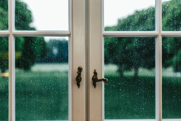 Closeup of original handles on the window covered with rain drop