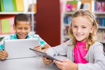 Fototapeta na wymiar Kids using digital tablet in library