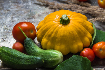 Squash, cucumbers, tomatoes on a metal background. Autumn, harvest.Copyspace
