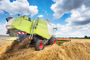 combine harvester working on a wheat field.