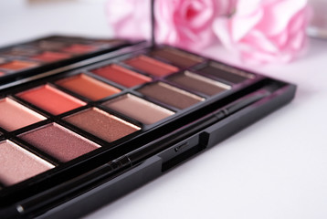 Eyeshadow makeup palette close up with roses 
